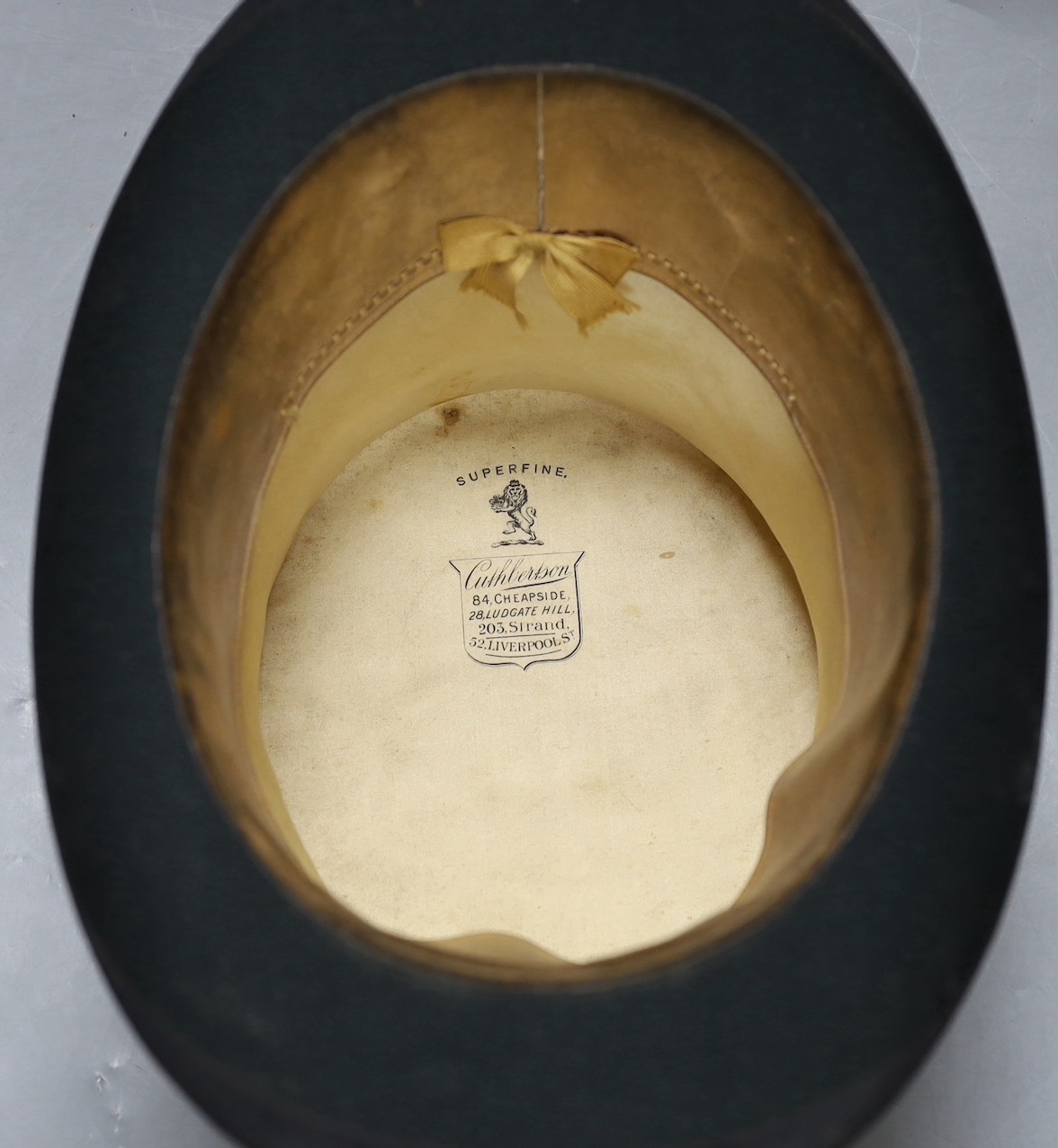 A leather cased Cuthbertson top hat, 19.5x15.5cm